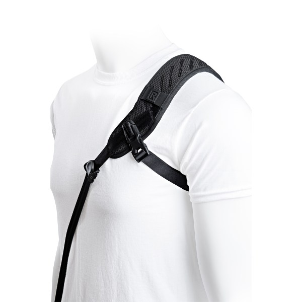 BlackRapid camera strap worn crossbody with camera attached at the hip, showing comfortable padded shoulder strap and FastenR connection.
