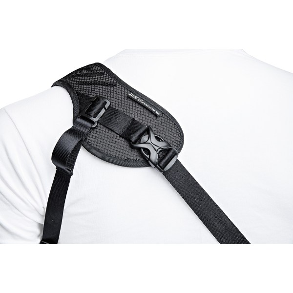 Close-up of BlackRapid Blackline I camera strap on shoulder, showing padded mesh and adjustable buckle.