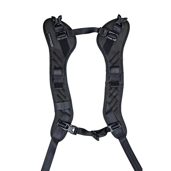 BlackRapid camera strap worn crossbody with camera resting at the user's side.